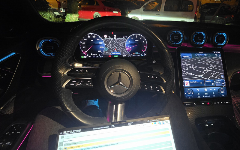 Mercedes-Benz MBUX interior with Xentry diagnostics on laptop